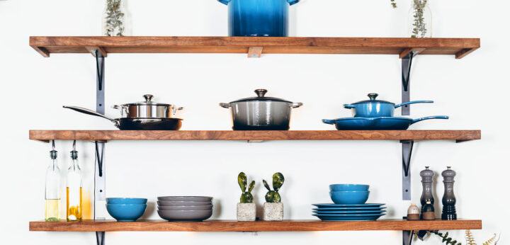 shelf above a sink with various cookware in a first apartment